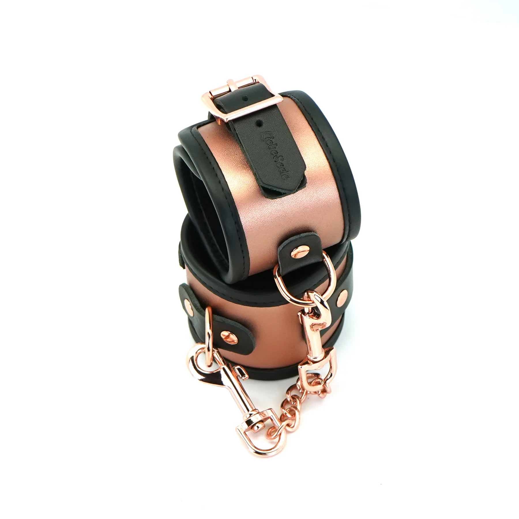 The Rose Gold Memory Leather Cuffs with Faux Fur LIning buckled and closed with one cuff resting on top of the other.