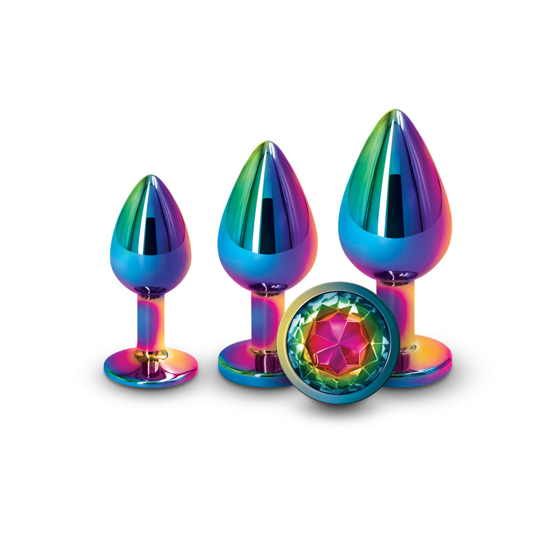 Three of the Rear Assets Rainbow Gem Trainer Kit plugs standing upright and one lying down to show the jeweled bottom.
