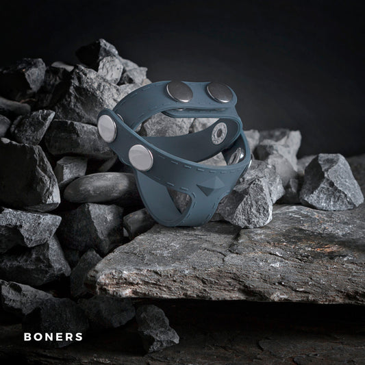 The Boners T-Shape Ball Splitter artfully balanced on gray rocks.