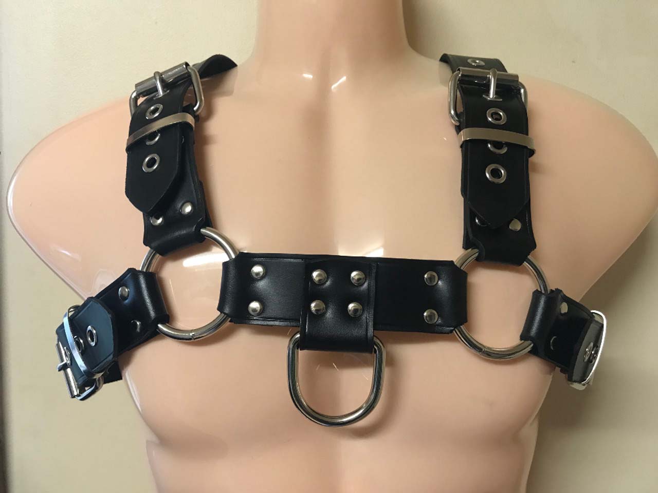 The Leather Bulldog Harness with D-Ring on a mannequin, front view.