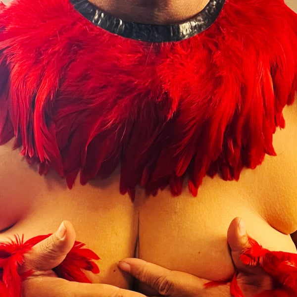 The red latex feather collar on a models neck.