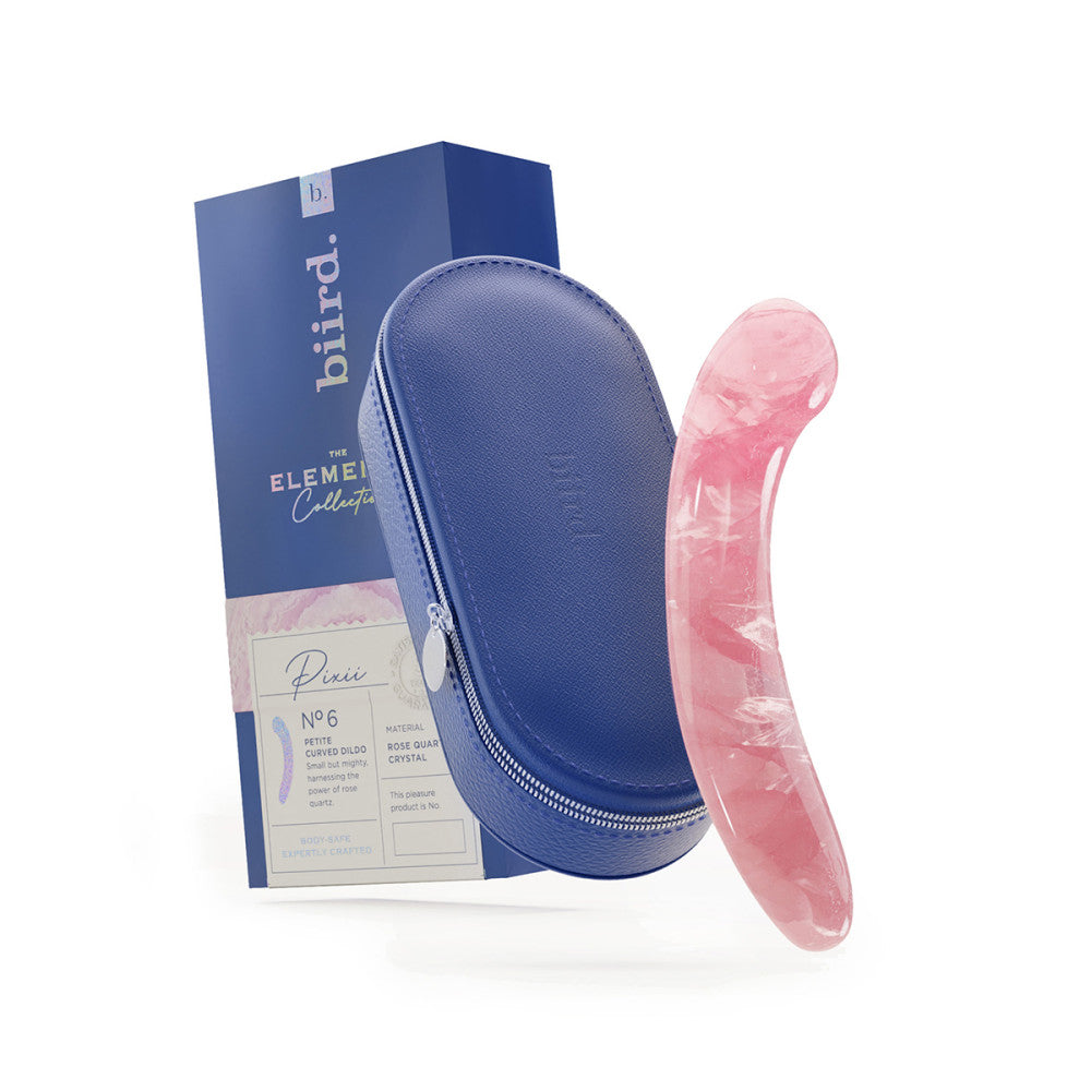 The Biird Pixii Rose Quartz Dildo next to its storage case and packaging.