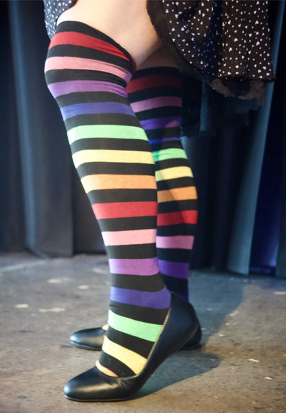 left leg of plus size model extended wearing Aurora Rainbow Over the Knee Rainbow Socks