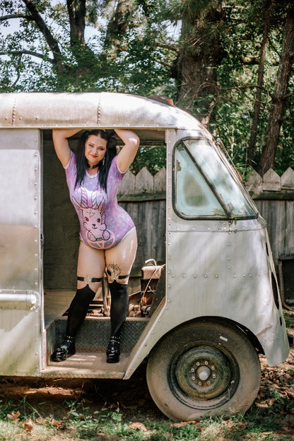 A model wearing the Demon Onesie and posing inside the door of a van.
