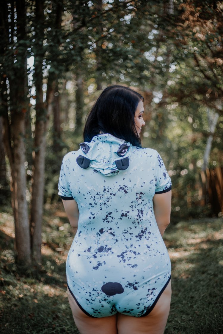 A plus size model showing the back of the Panda Hooded Onesie.