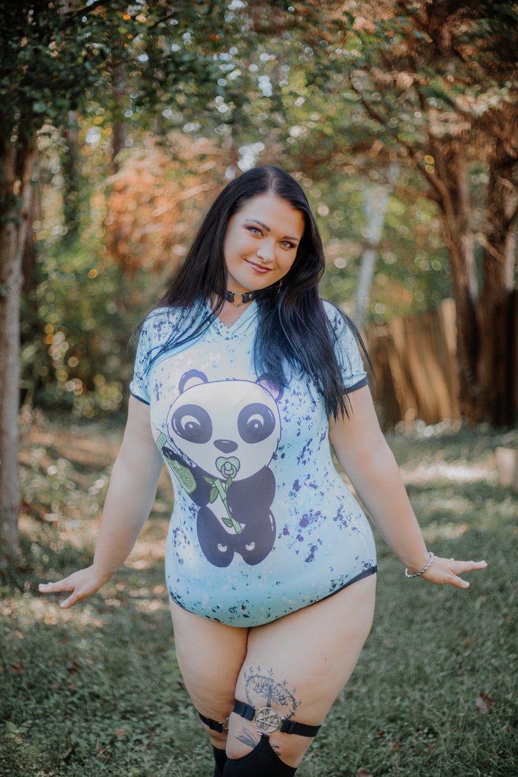 A plus size model showing the front of the Panda Hooded Onesie.