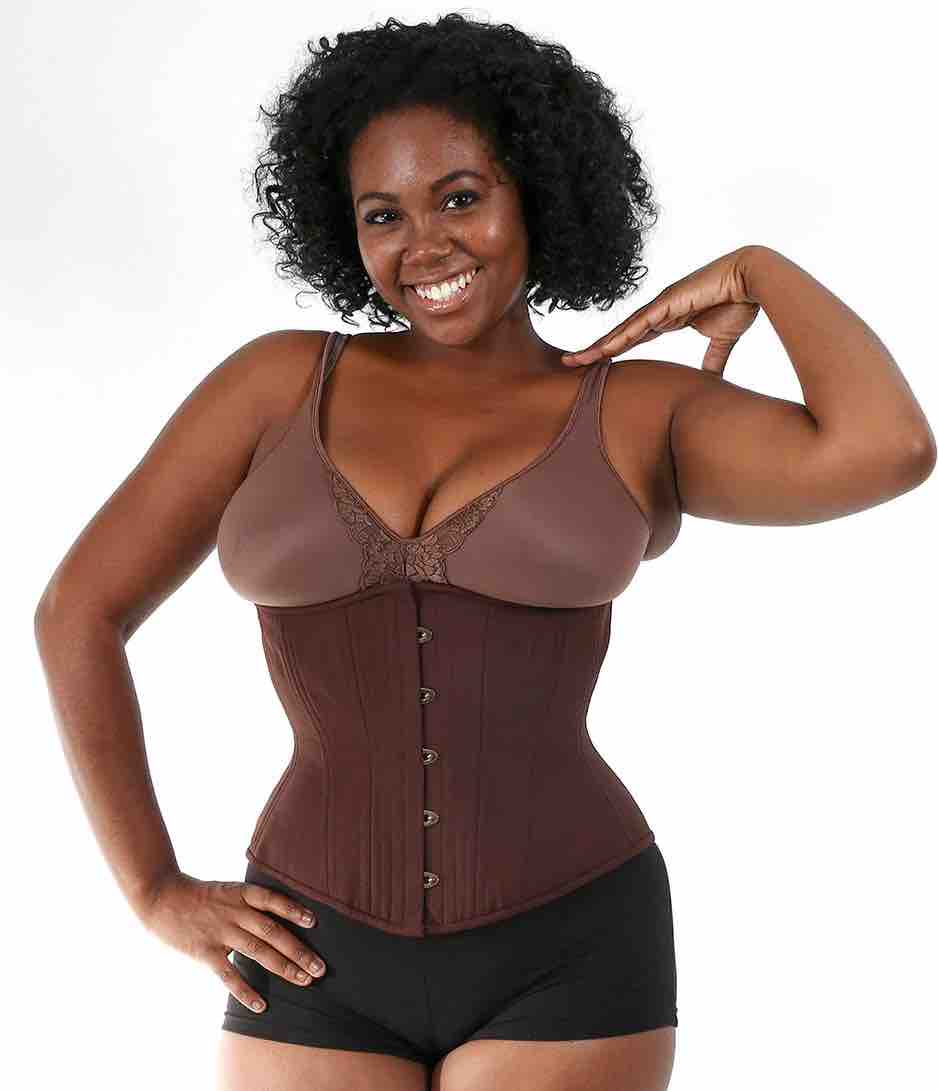 A model wearing the chocolate Cotton Shapewear Mid Length Underbust Corset- Hourglass over a brown bra and black shorts.