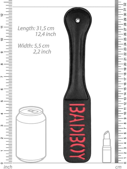 An illustration of the Bad Boy Impressions Paddle with rulers standing next to a cola can and a lipstick for size comparison.