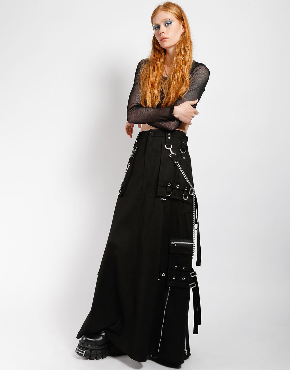 The front and left side of the Strength Maxi Kilt on model wearing a long sleeve fishnet top..