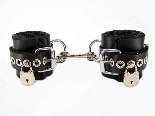 Black with Black satin lined bondage cuffs with tentacle eyelets and locks on each cuff.