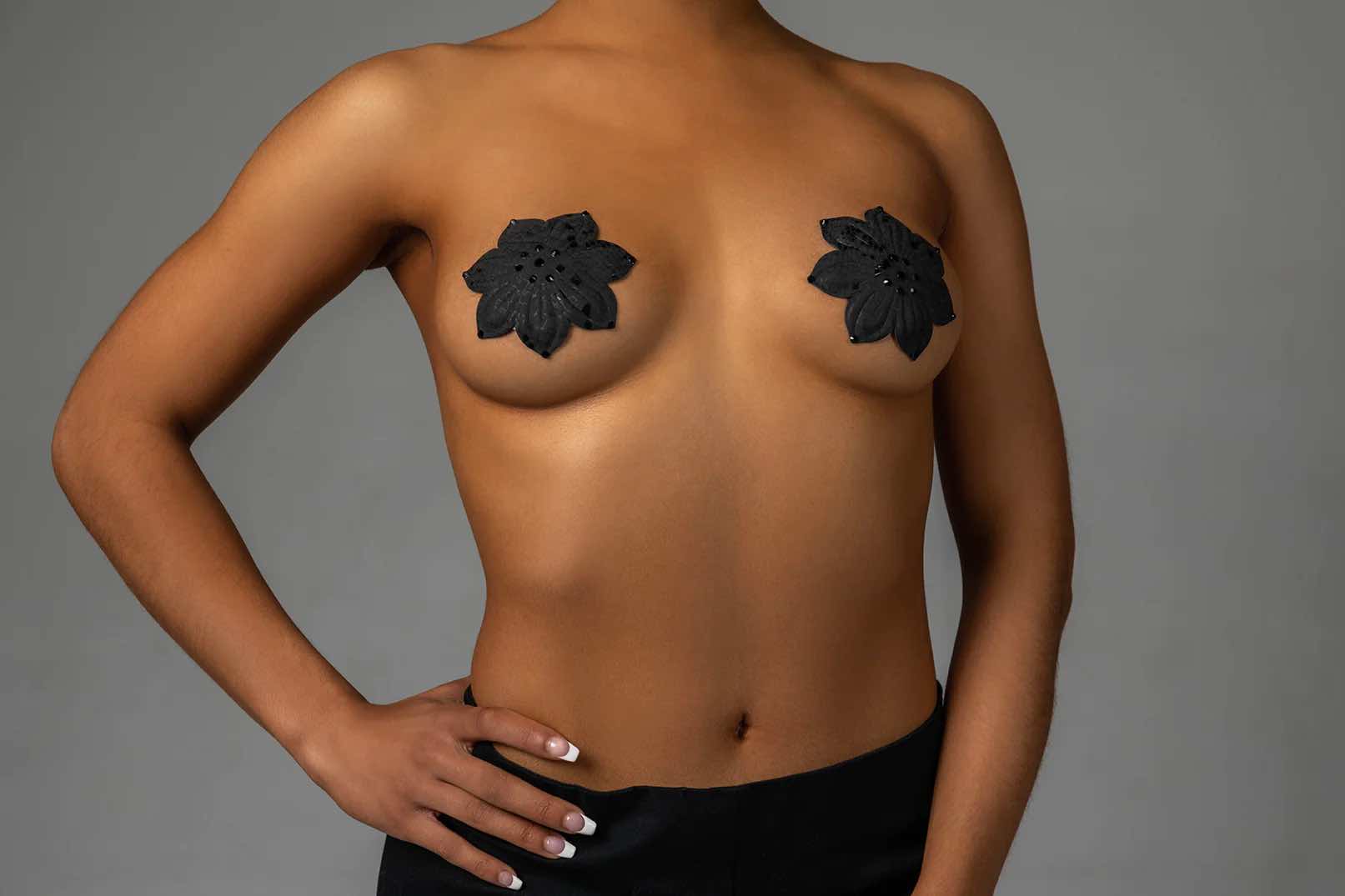 A model wearing the black Athens Deluxe Reusable Pasties by Blissidy.