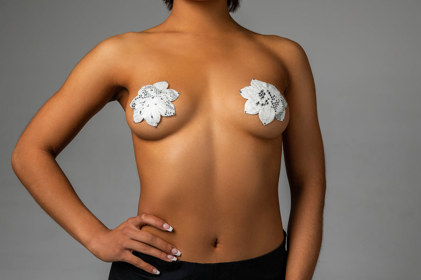 A model wearing the White Athens Deluxe Reusable Pasties by Blissidy.