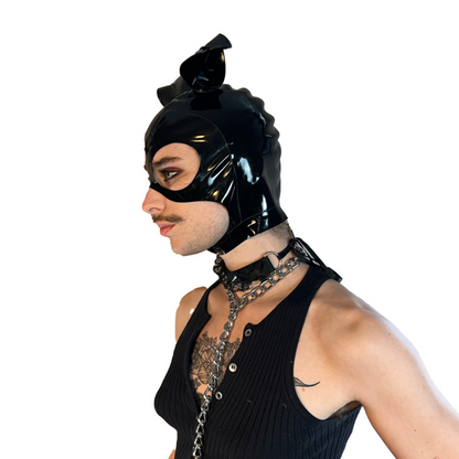 A model wearing black with magnetic ears open mouth and eye basic latex hood, side view.