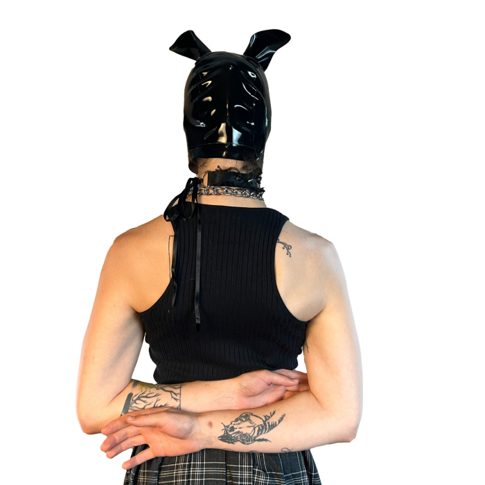 A model wearing black with magnetic ears open mouth and eye basic latex hood, rear view.