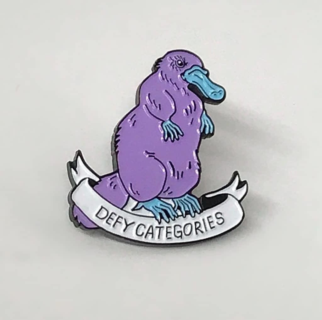 The Platypus Defy Categories lapel pin.