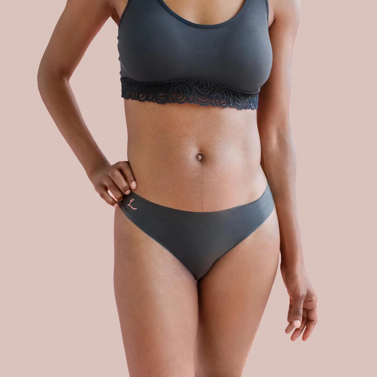 A model wearing the opaque black bikini Lorals Panties For Pleasure and Comfort, front view.