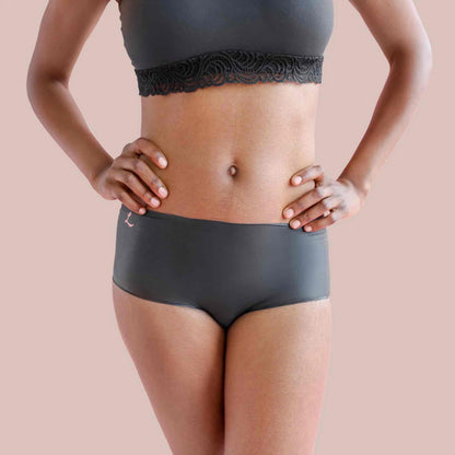A model wearing the opaque black shortie Lorals Panties For Pleasure and Comfort, front view.