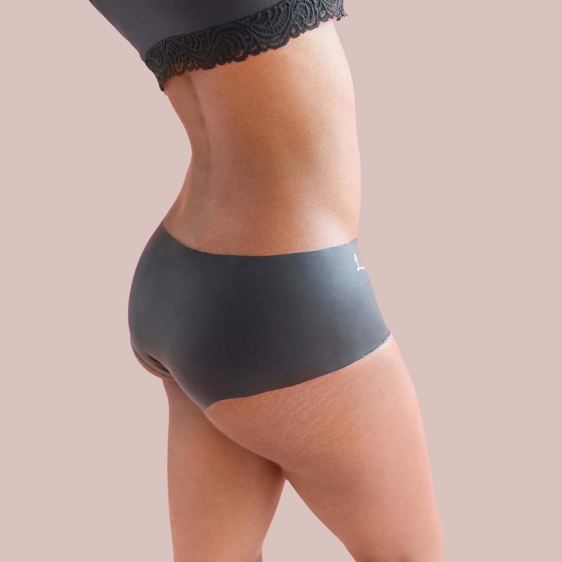 A model wearing the opaque black shortie Lorals Panties For Pleasure and Comfort, side view.