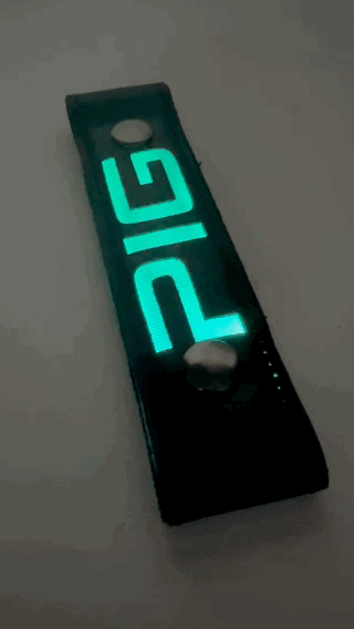 A Gif of the "PIG" Glow Center Strap flashing in different colors.