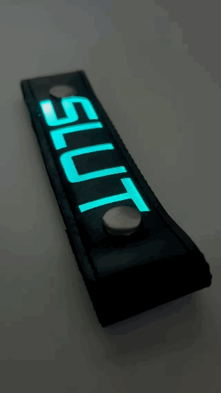 A Gif of the "SLUT" Glow Center Strap flashing in different colors.