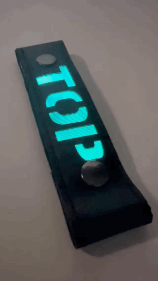 A Gif of the "TOP" Glow Center Strap flashing in different colors.