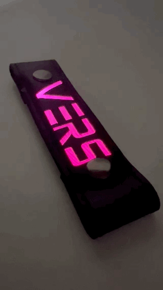 A Gif of the "VERS" Glow Center Strap flashing in different colors.