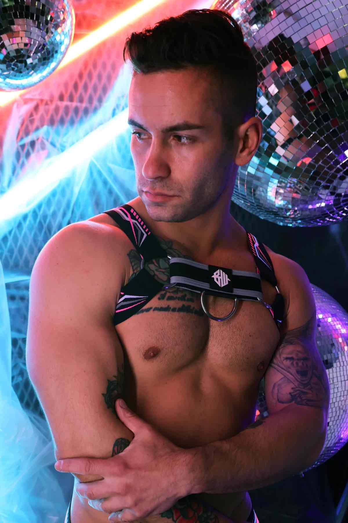 Model wearing the neon pink Cyber Nights Harness, front view.