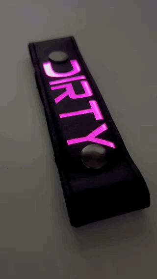 A Gif of the "DIRTY" Glow Center Strap flashing in different colors.