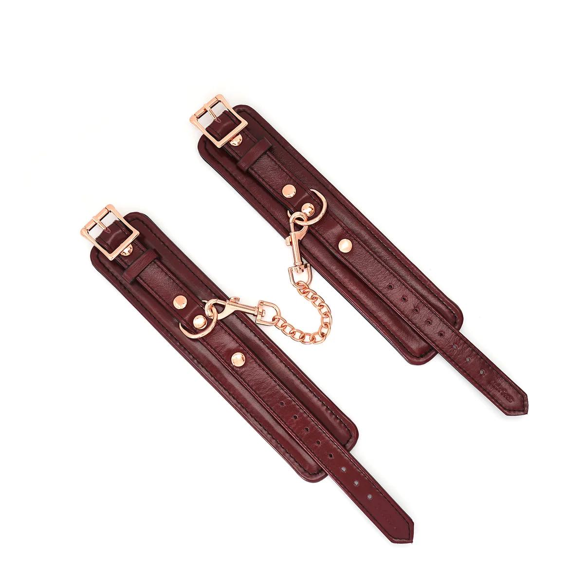 The Burgundy Leather Cuffs with Rose Gold Hardware laid flat next to each other.