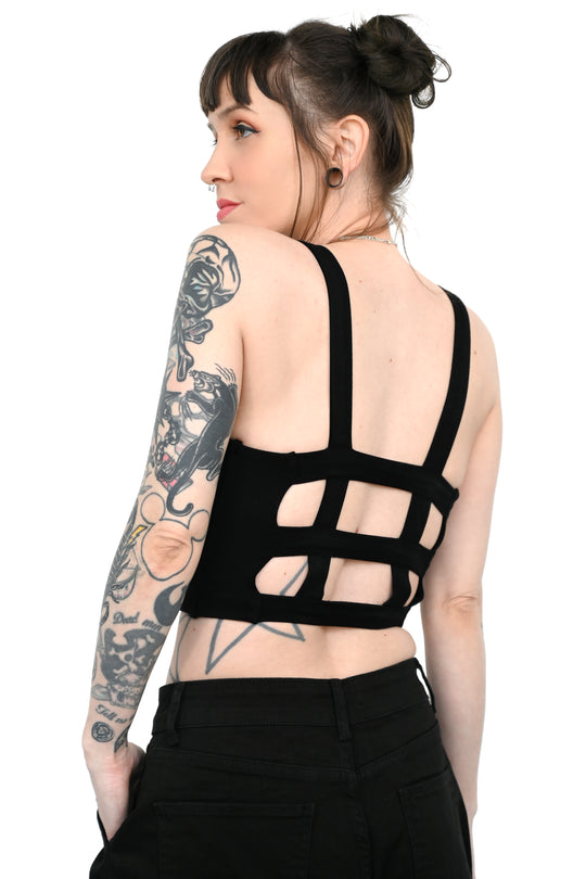A model showing the strappy back of the Alaia Crop Top.
