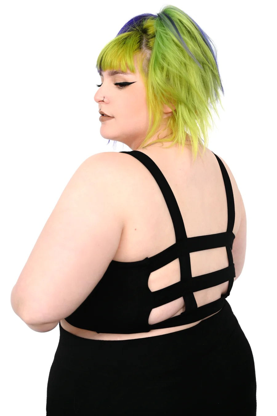 A plus size model showing the strappy back of the Alaia Crop Top.