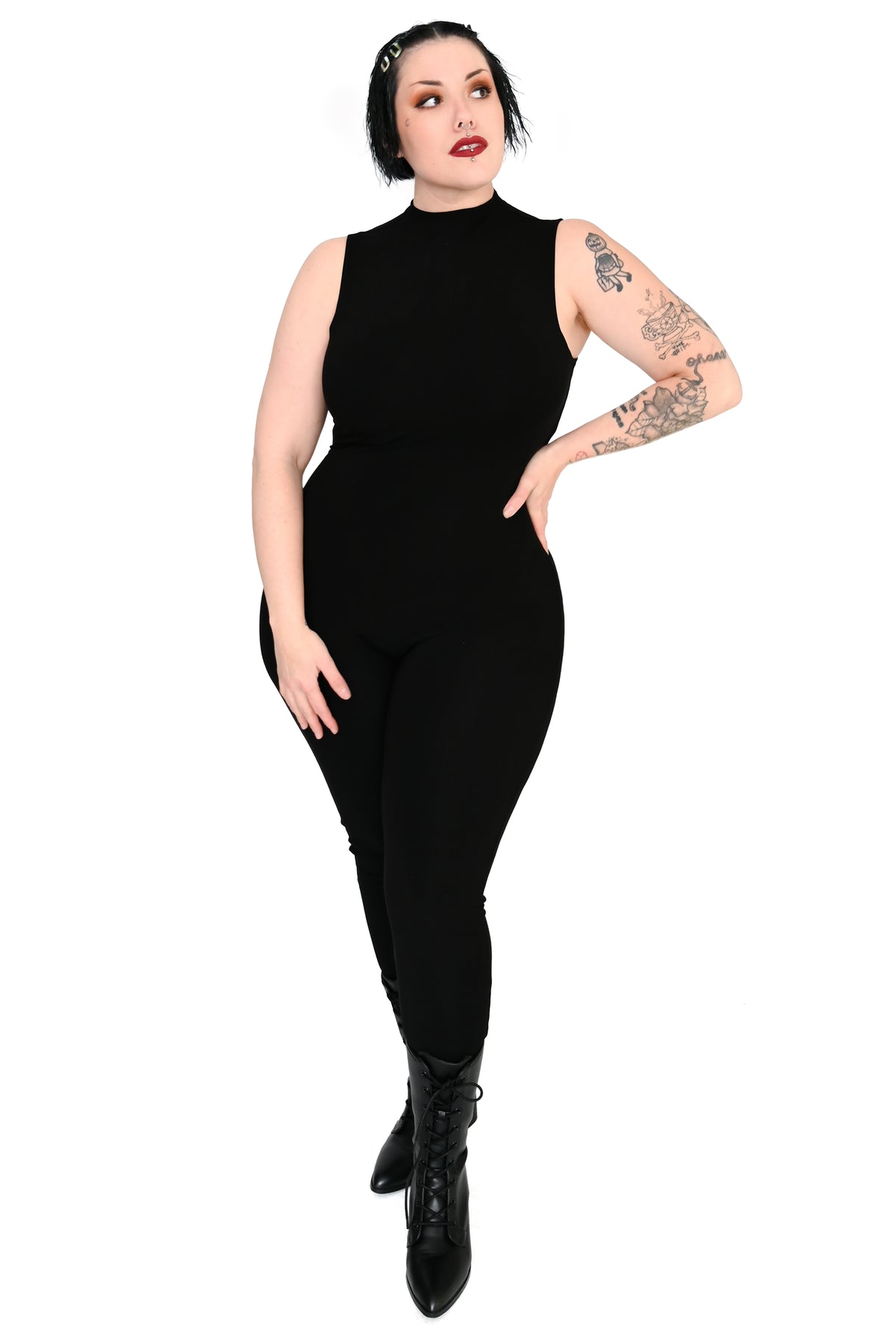 Front view of curvy goth model wearing signature high neck catsuit