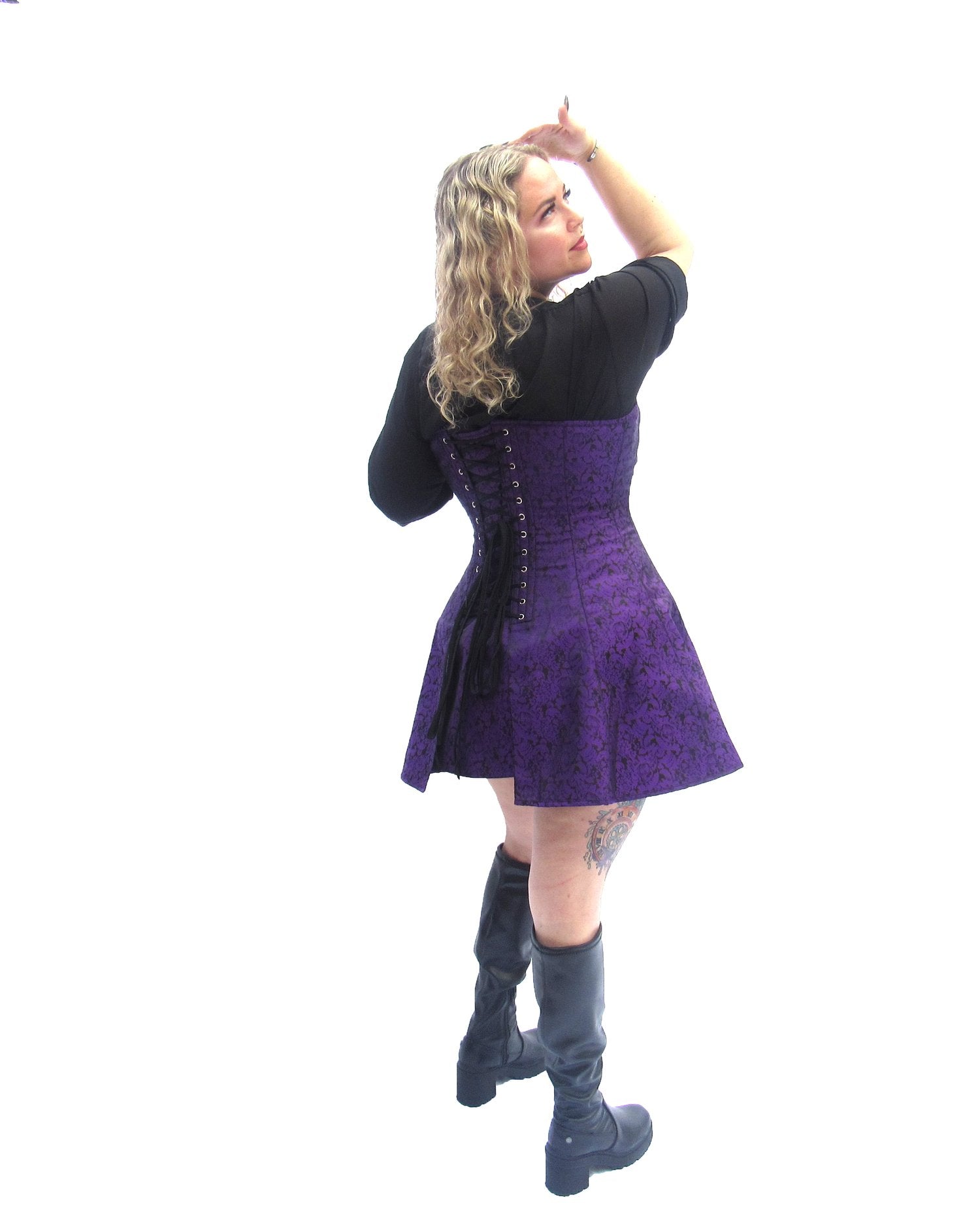 A model wearing the purple brocade Skirted Overbust Corset, rear view.