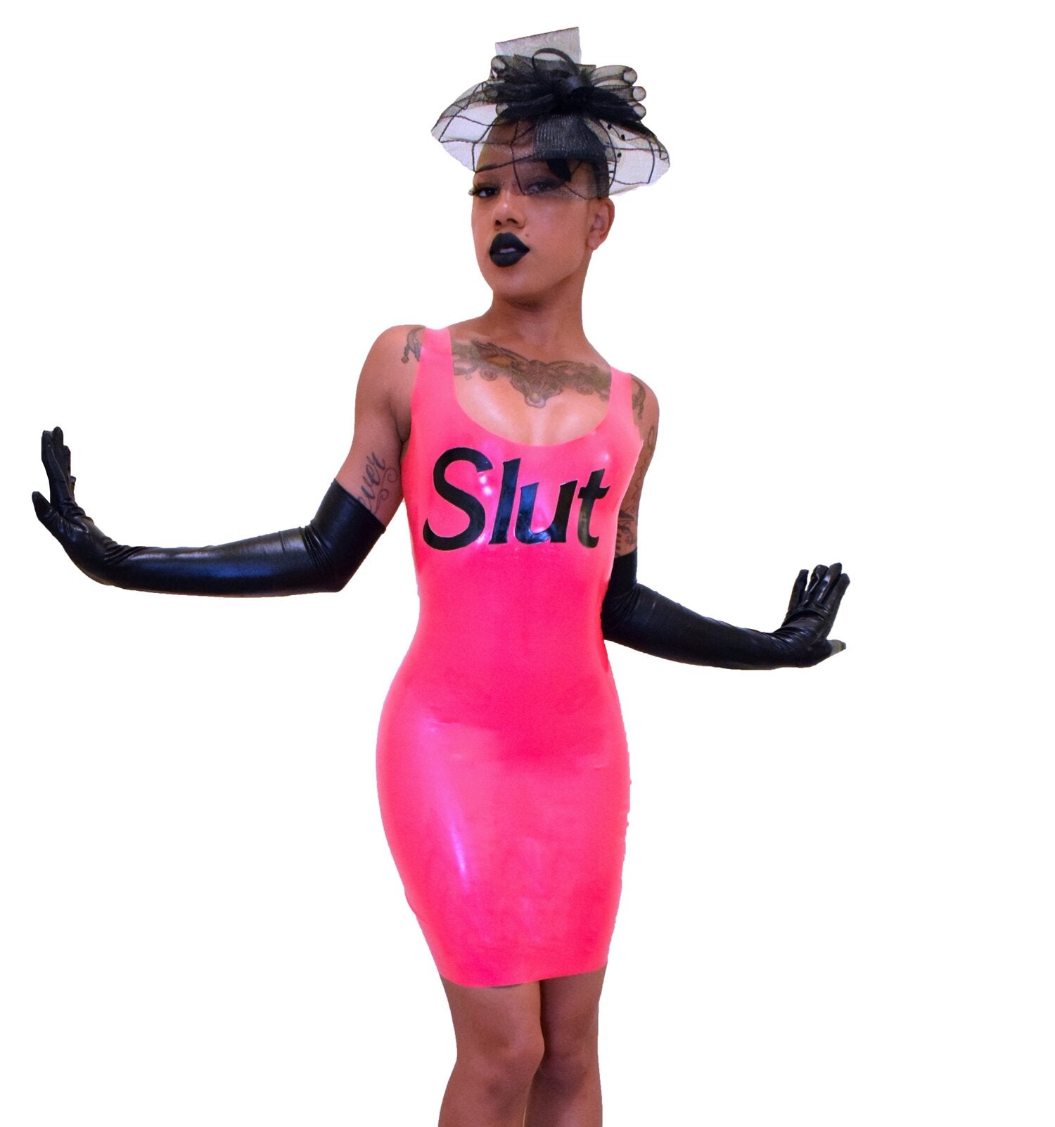 Model wearing neon pink slut dress with hat and long gloves
