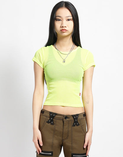 A model wearing the yellow Baby Short Sleeve Fishnet Tee Shirt with black pants, front view.