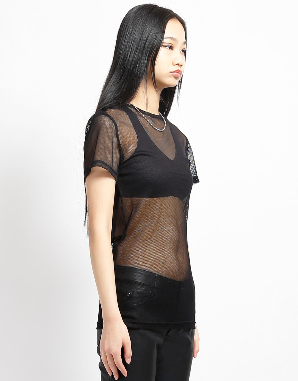 Model wearing the black Short Sleeve Fishnet T-Shirt with black bra and pants, front and right side view.