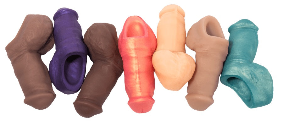 A group of Sam Stand to Pee Packer Penis dildos including the flesh, purple, teal and rose gold colors.