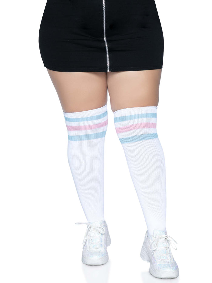 Plus size model wearing the Trans Pride Over The Knee Athletic Socks with white sneakers and black skirt.