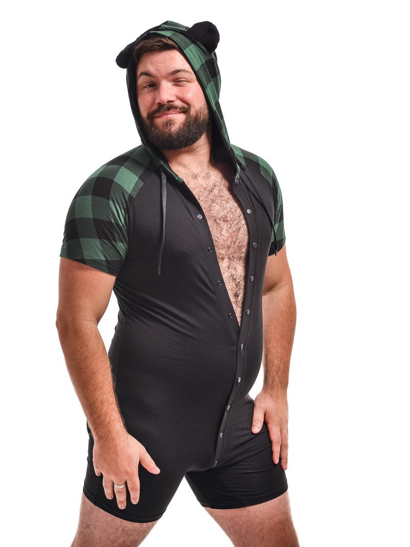 A model wearing the green plaid and black bear onesie, side view.