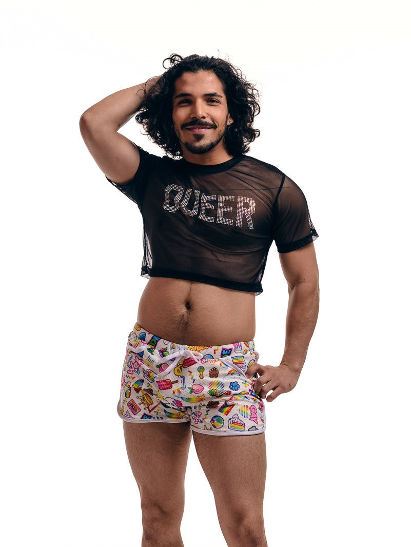 A model in colorful boxer shorts wearing the Mesh Queer Crop Top, front view.