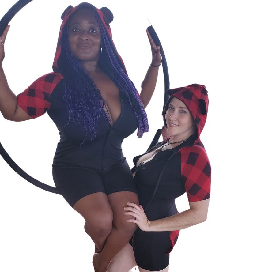 2 Aerial performers, one sitting in a hanging hoop with the other standing, both wearing red with black Bear Plaid Bamboo Onesies.