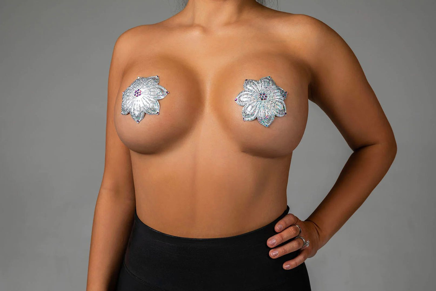 A model wearing the Silver Iridescent Speckle Miami Deluxe Reusable Pasties by Blissidy.