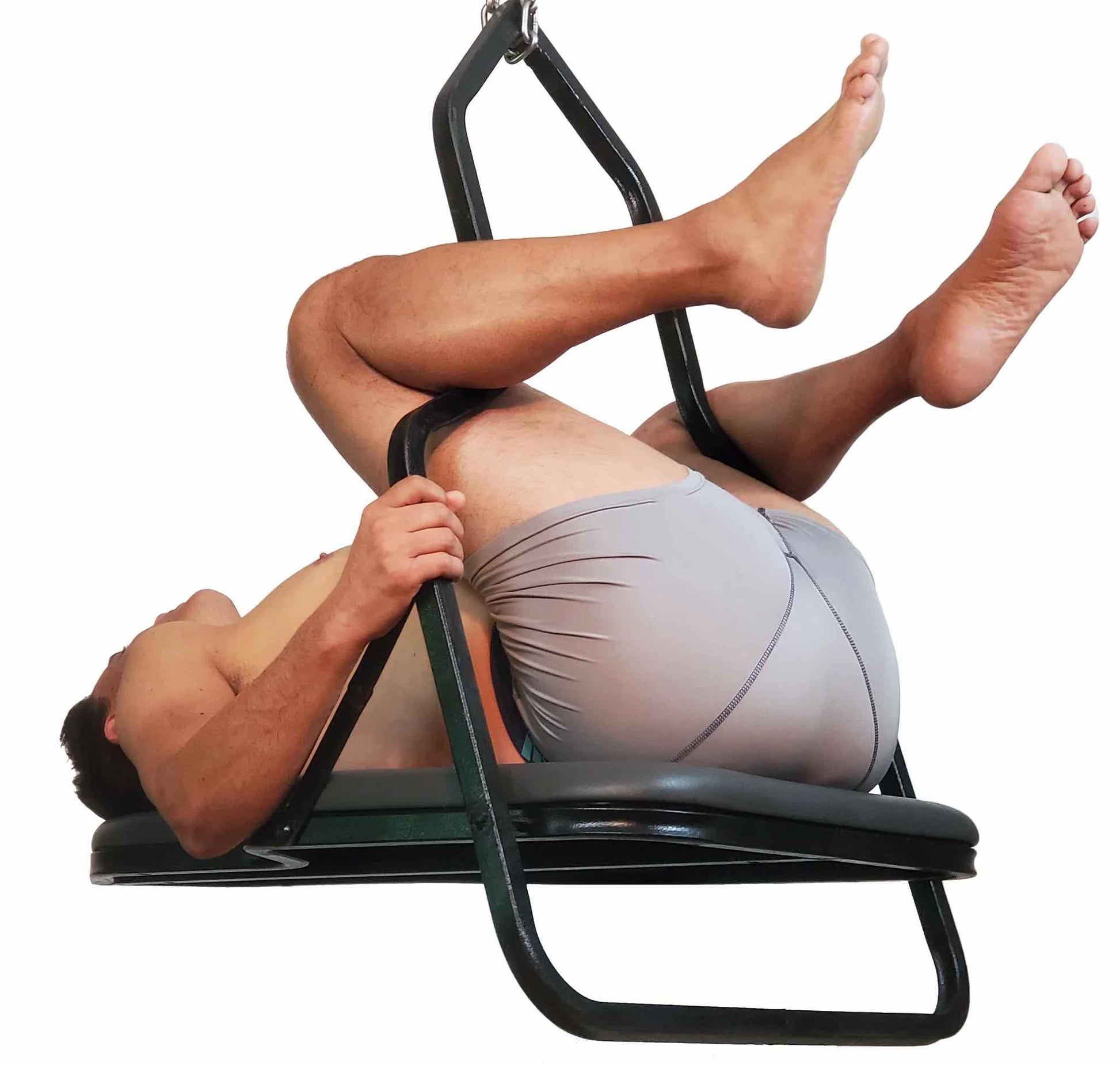 A model in light grey boxer shorts laying in the Sling Swing Model A.
