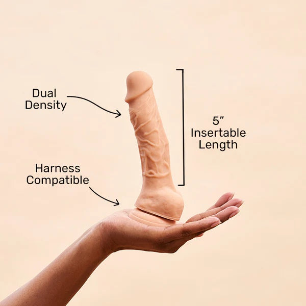 A hand holding the Vanilla dual density dildo surrounded by an illustration of its features.