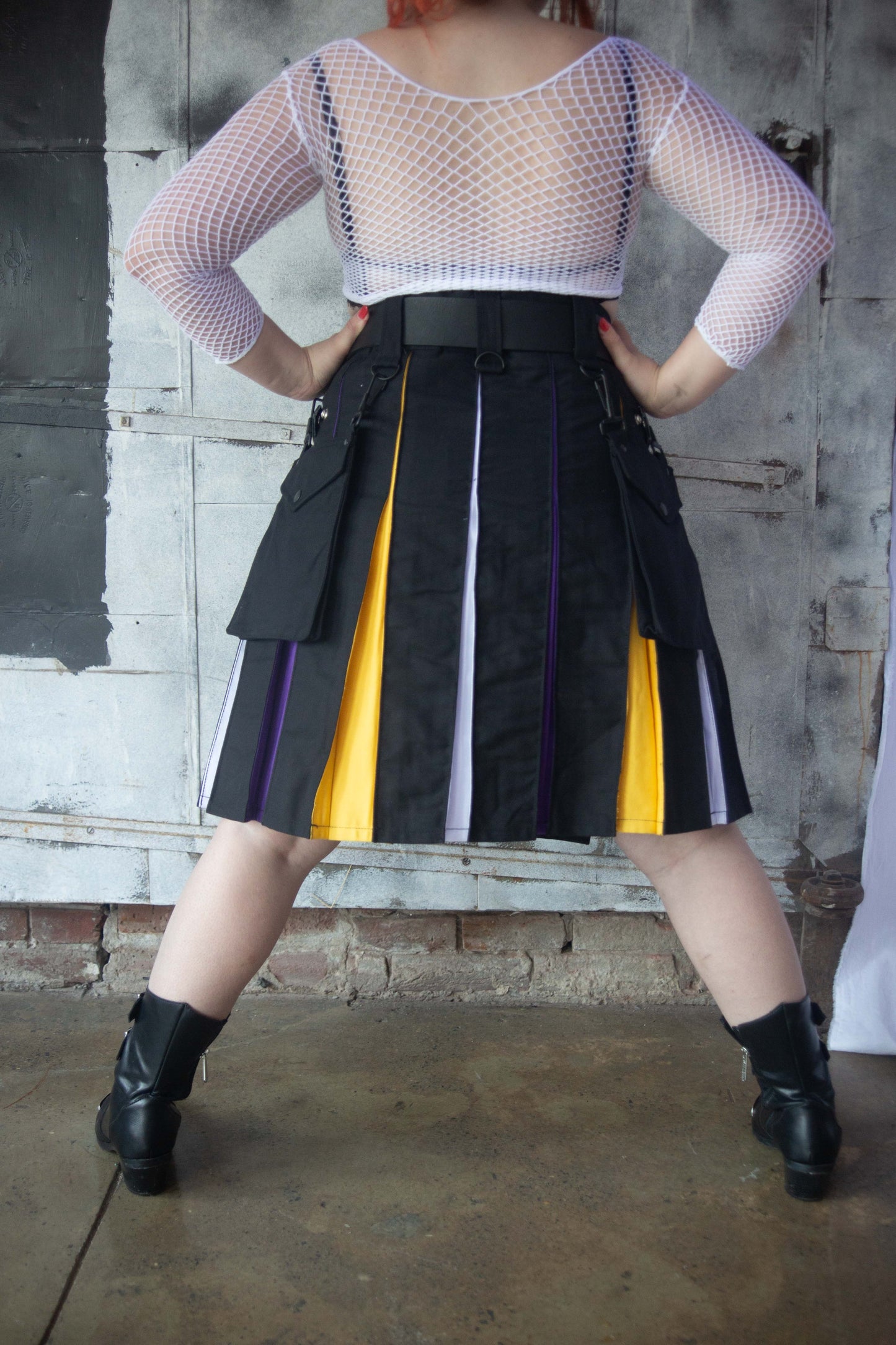 model facing backwards with hands on hip, wearing Nonbinary Pride Flag Heritage Kilt