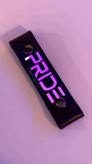 A Gif of the "PRIDE" Glow Center Strap flashing in different colors.