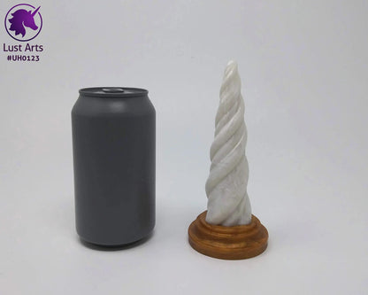 The Firm Teaser Sunlight Unicorn Horn Dildo standing upright next to a cola can for size reference.