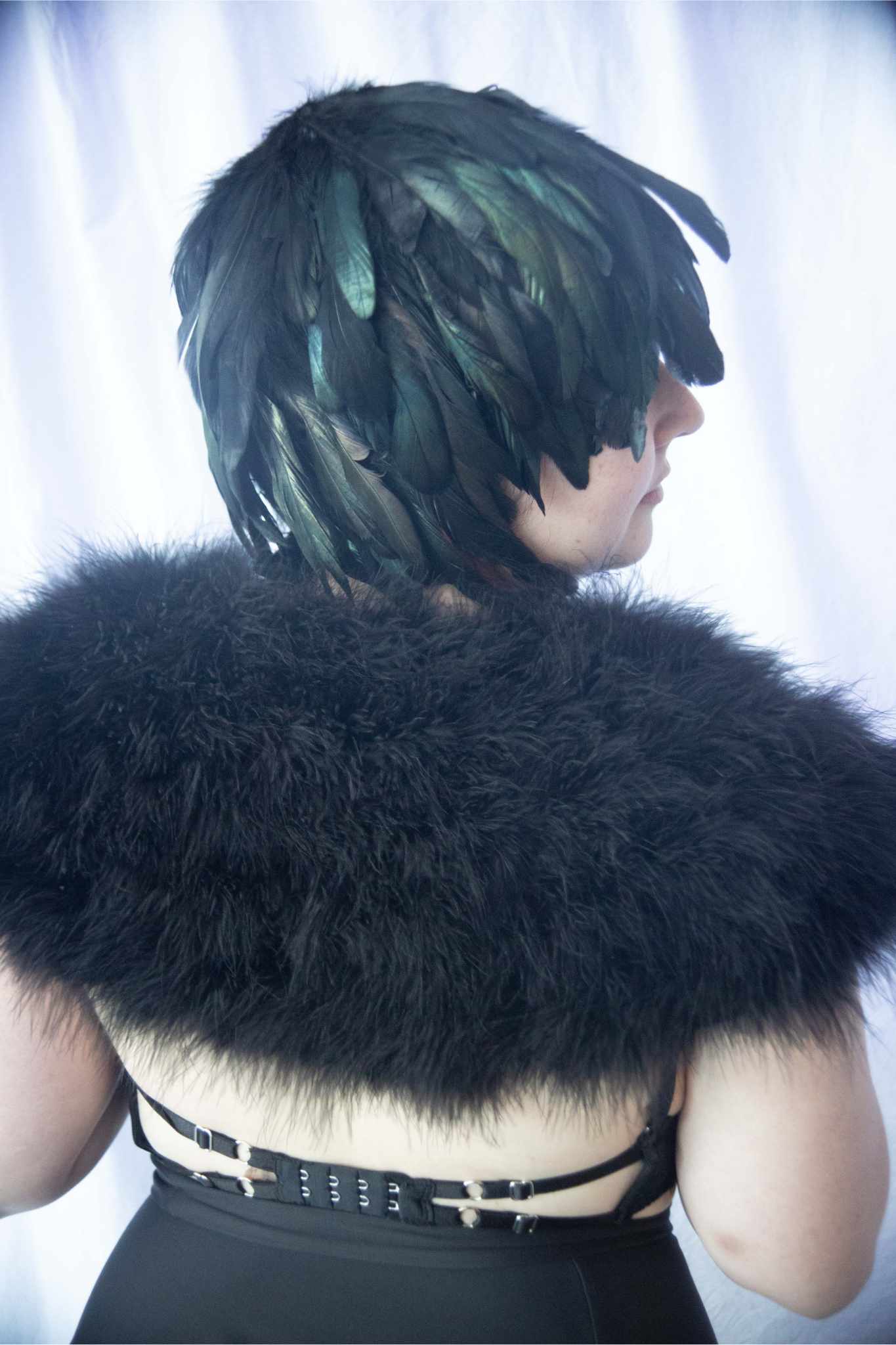 model facing right/back wearing Schlappen Feather Wig