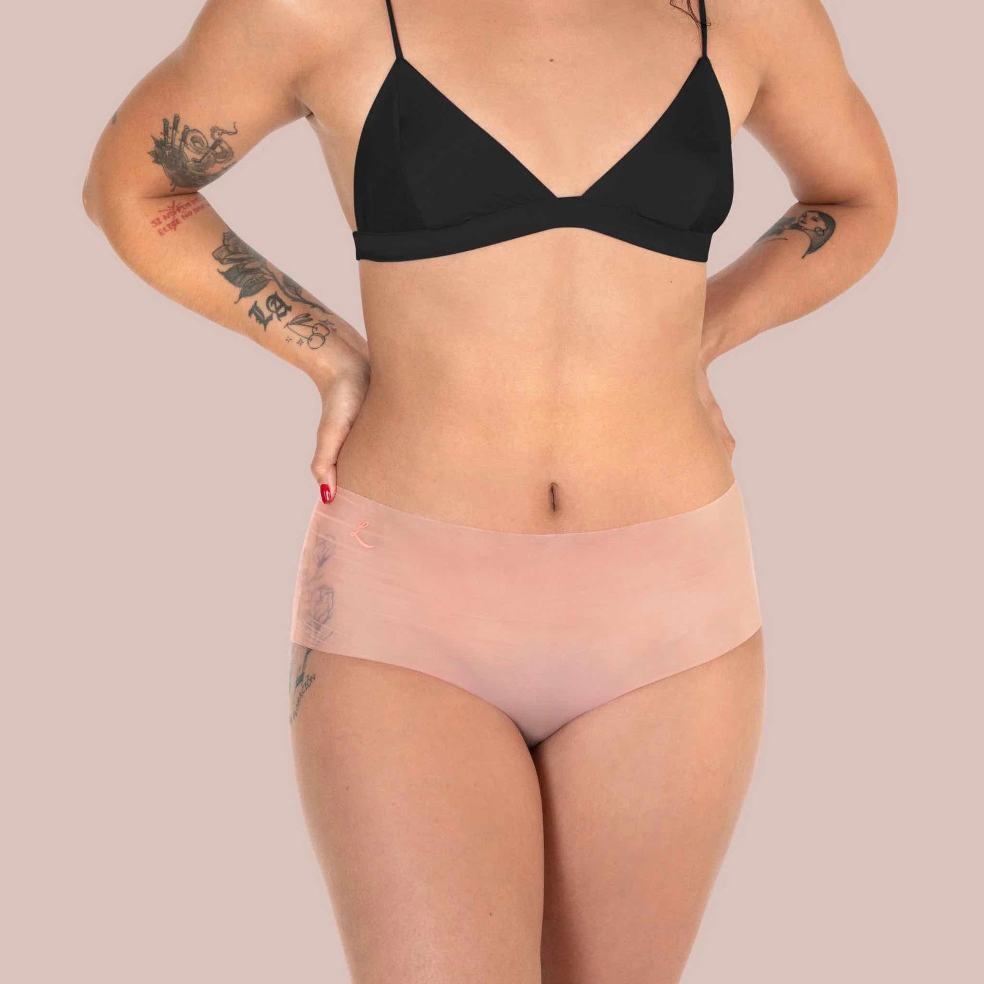 A model wearing the sheer peach shortie Lorals Panties For Pleasure and Comfort, front view.
