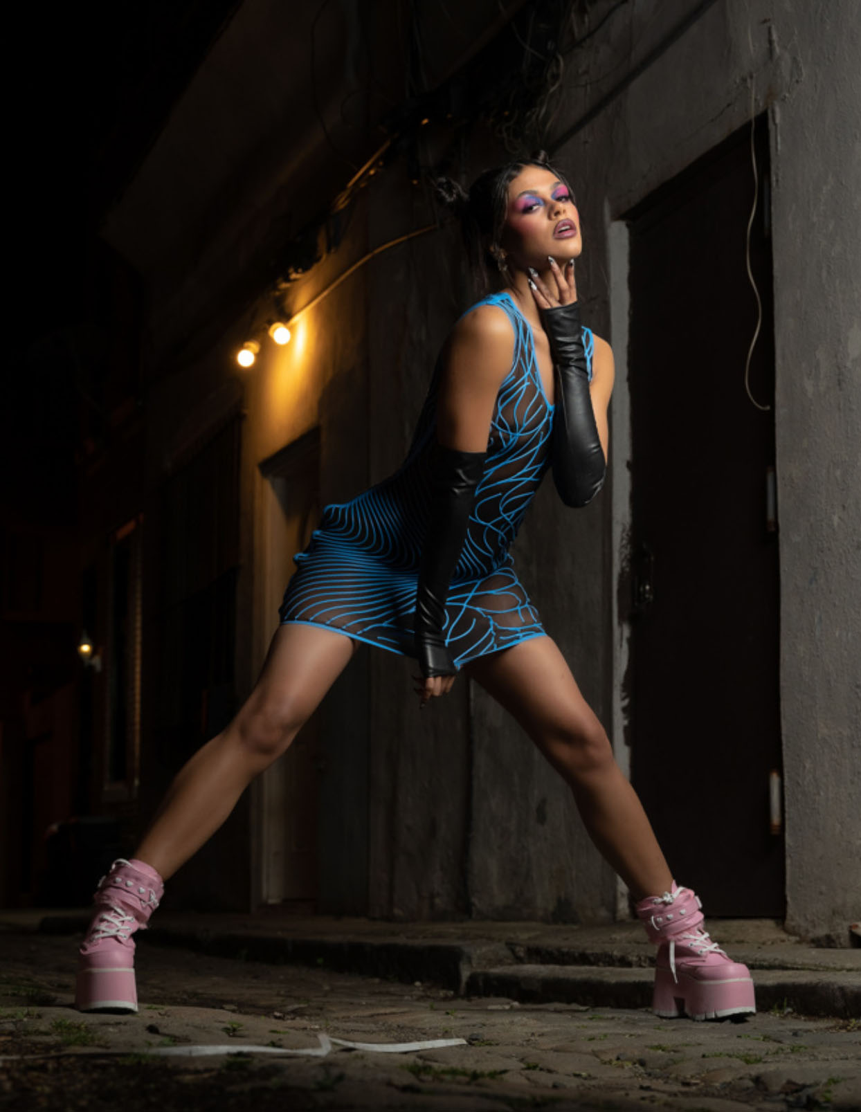 model standing in ally bent forward wearing Datex Mesh Dress with Swirl Pattern